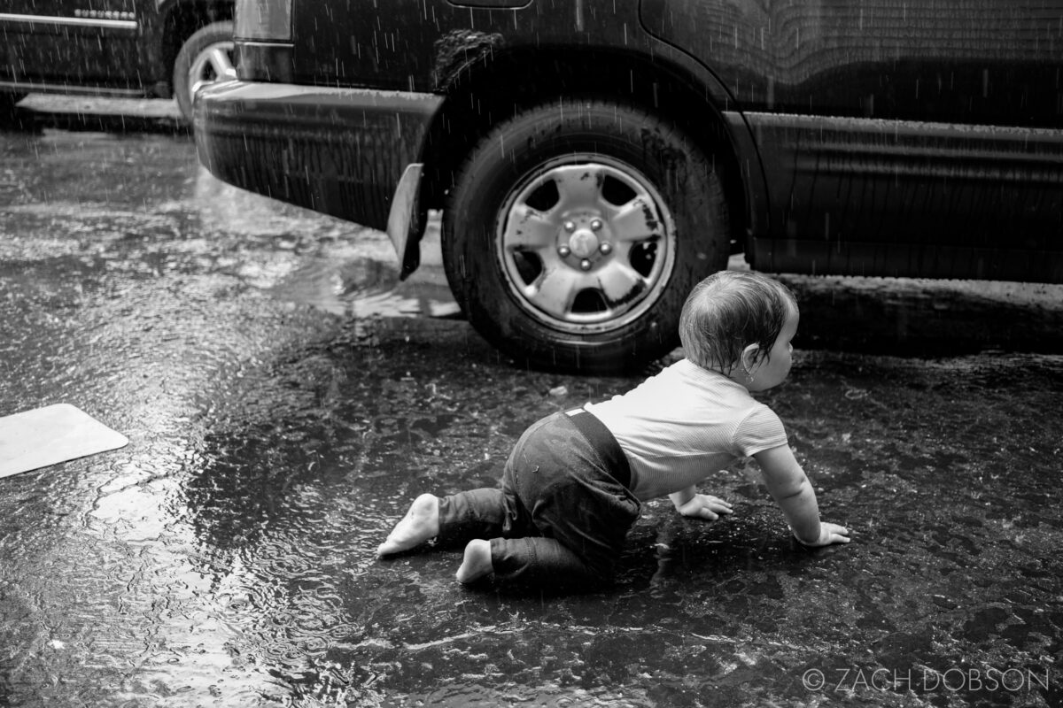 toddler playing in the rain
