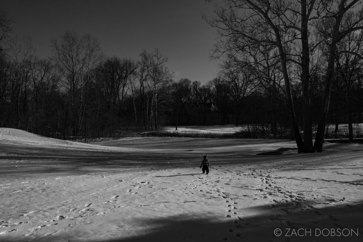 snow toddler black and white photography