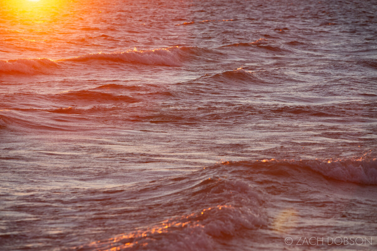 Rising sun on the waves of Lake Huron at Hoeft State Park in Rogers City, Michigan
