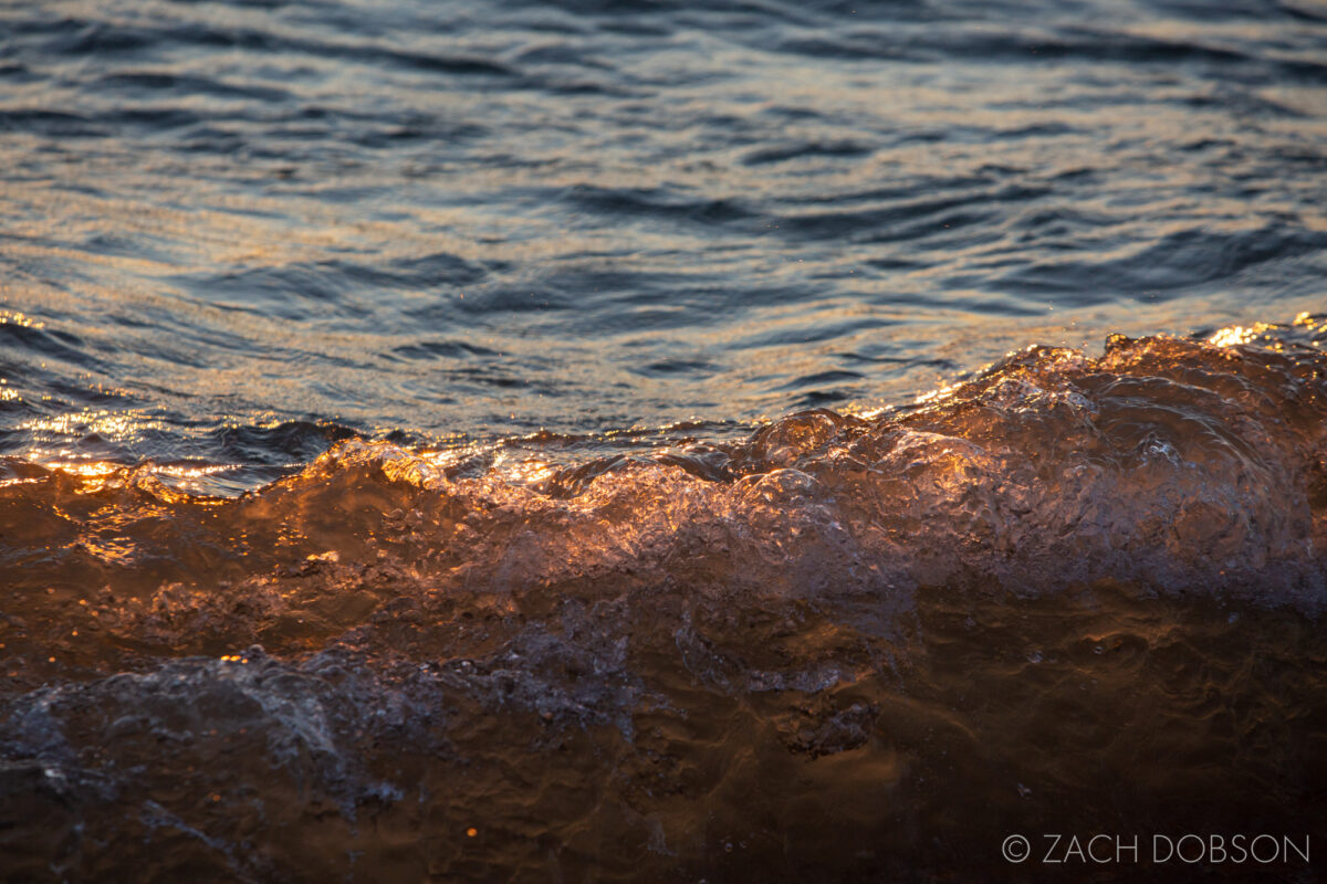 A wave during sunrise at the beach on Lake Huron at Hoeft State Park in Rogers City, Michigan