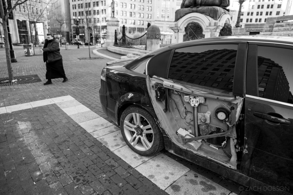 street photography with the Canon R5 for Roberts Camera in Indianapolis. abandoned car on monument circle