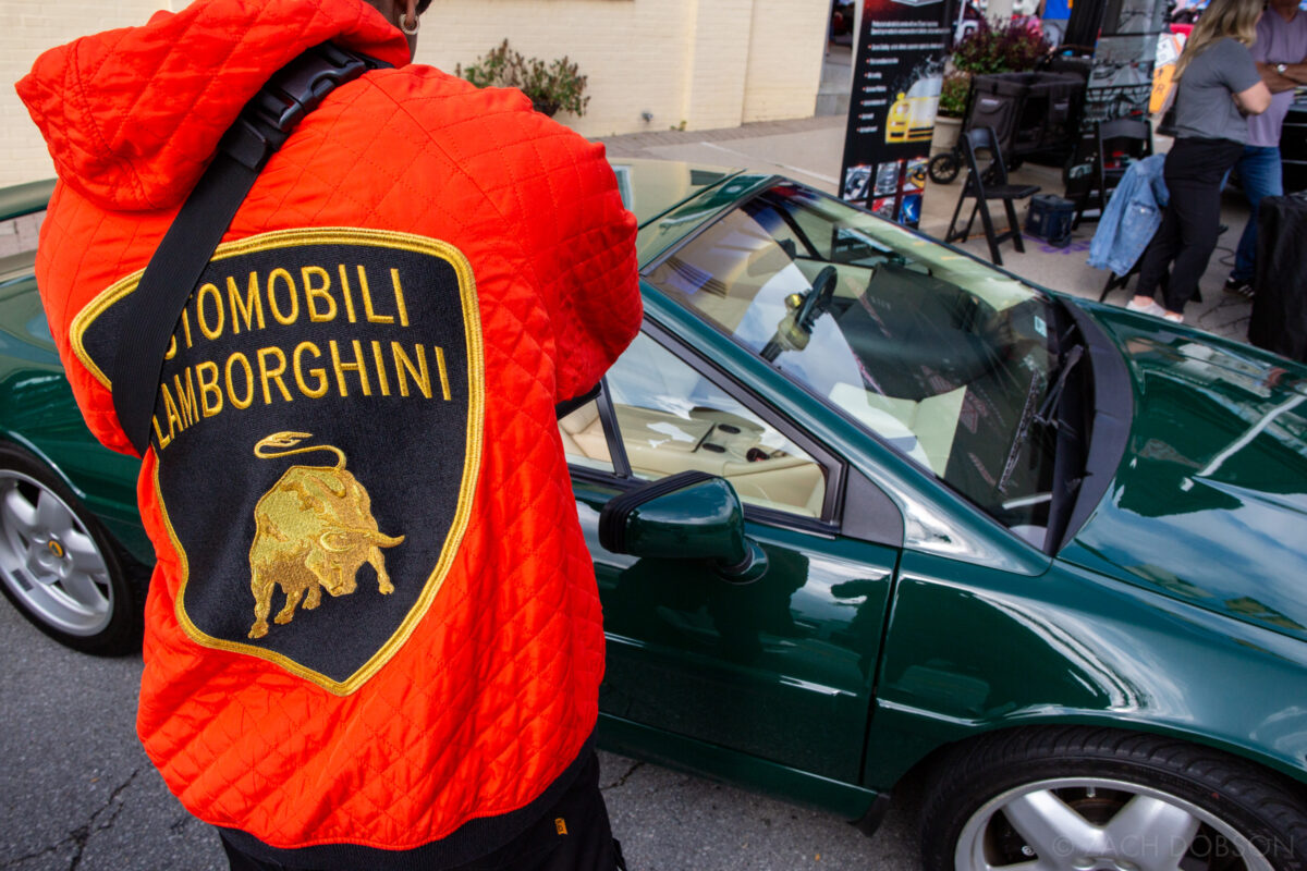 carmel artomobilia in the carmel arts & design district, indiana, orange lamborghini jacket and green lotus car