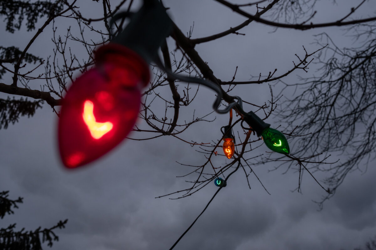 "Clouds & Lights" ©Zach Dobson Top 10 Photos 2024 
 Holiday lights in color against a cloudy sky at dusk. Carmel, IN