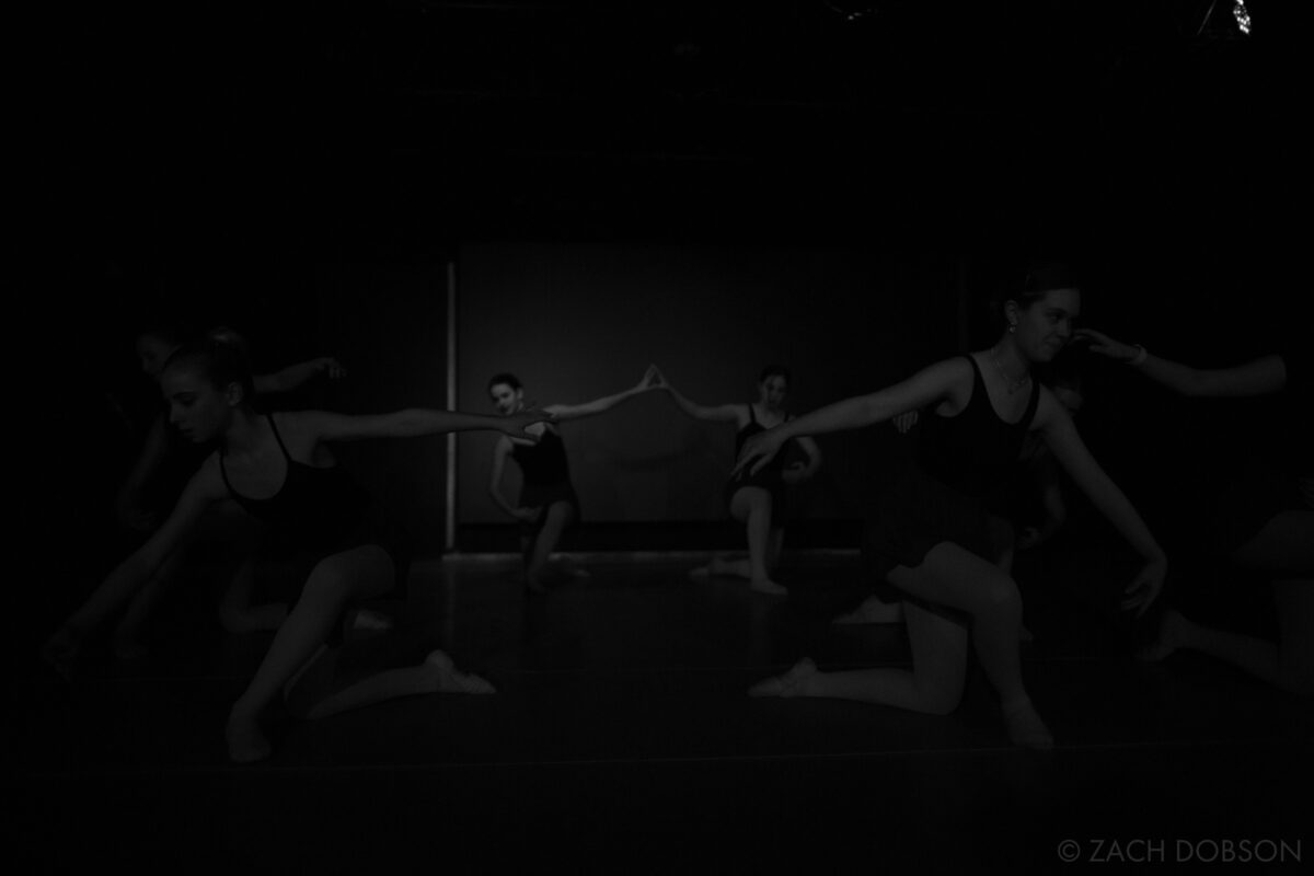"Dancing in the Dark" ©Zach Dobson Top 10 Photos 2024  Dancers on stage as the lights dim. Carmel, Indiana.