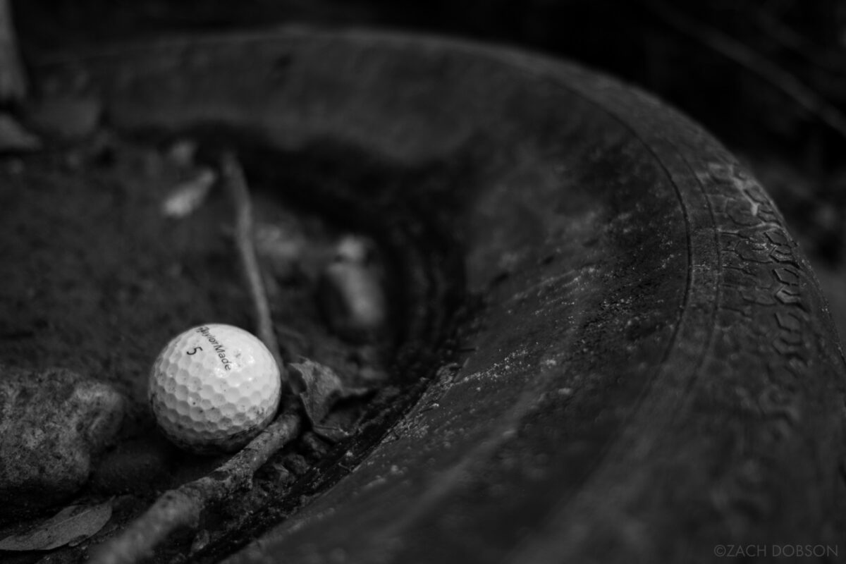 a lost golf ball found its way into an abandoned tire in a creek bed. This is exactly how I found it! For the As it Lies photo book.