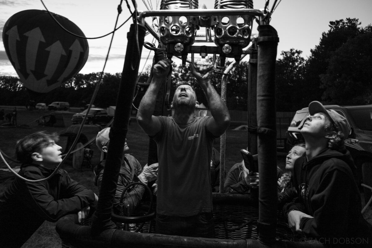 Black and white image of people in Hot air balloon basket- Jupiter Flights Balloon Festival at Conner Prairie Image: Zach Dobson Photography