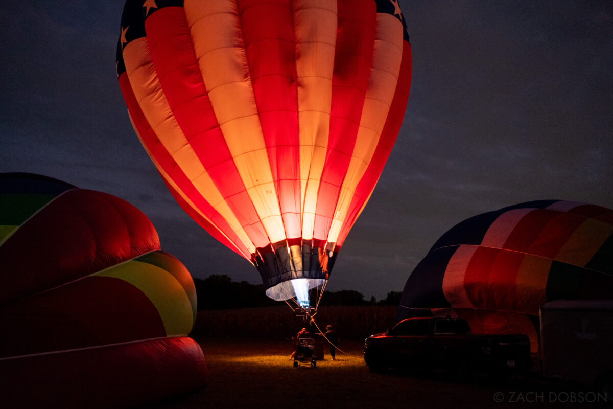 American flag hot air balloon lit up against the night sky at the Jupiter Flights Balloon Festival at Conner Prairie Image: Zach Dobson Photography