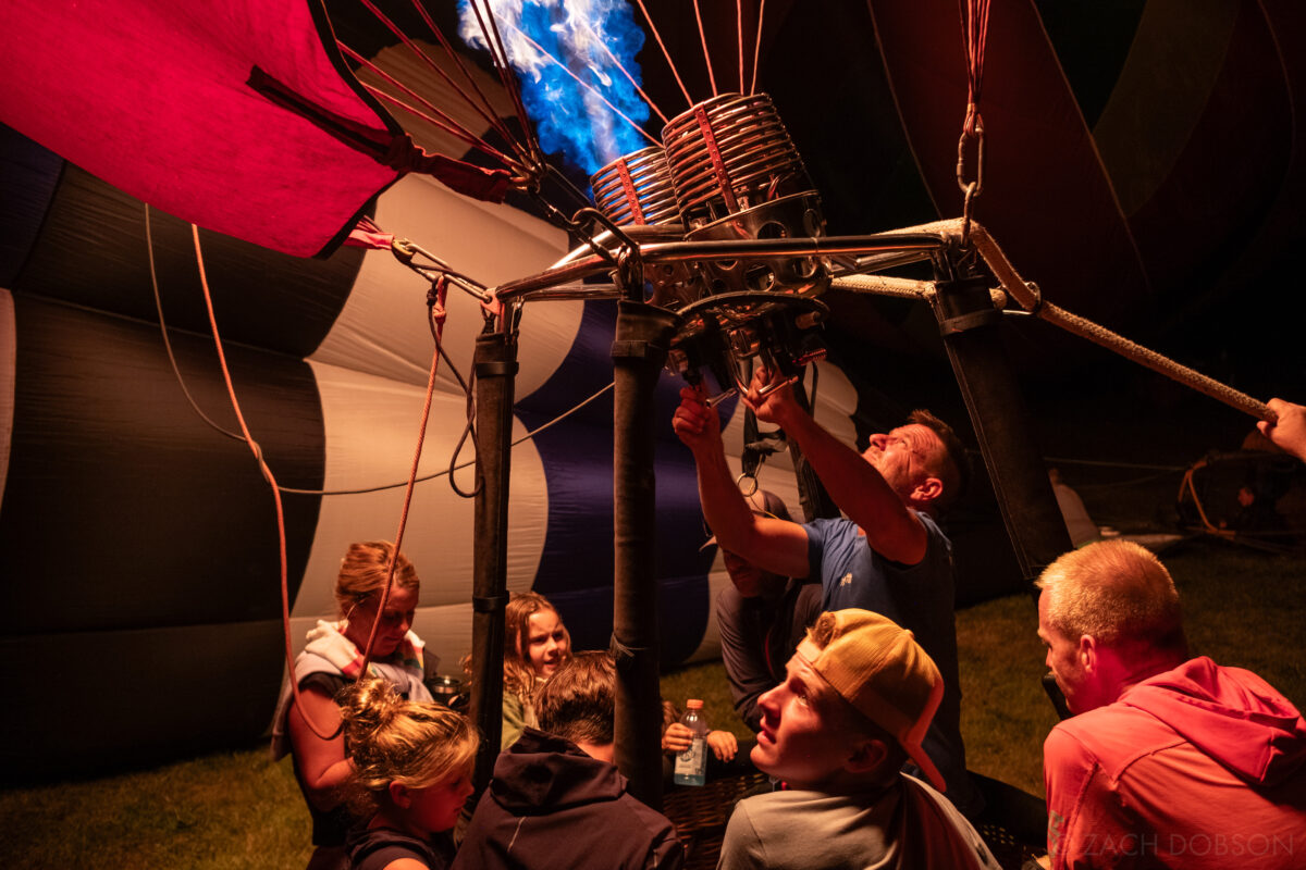 A family sitting in a Hot air balloon - Jupiter Flights Balloon Festival at Conner Prairie Image: Zach Dobson Photography