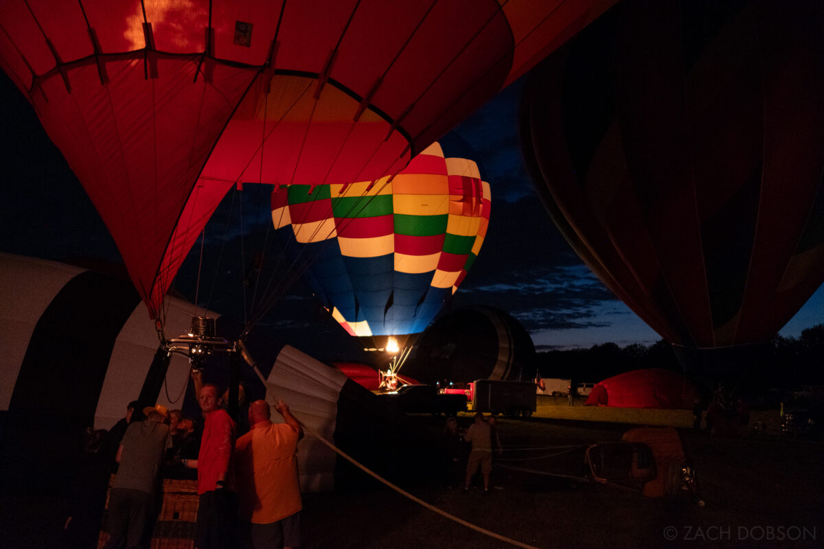 Hot air balloons lit against the night sky. Balloon Glow - Jupiter Flights Balloon Festival at Conner Prairie Image: Zach Dobson Photography