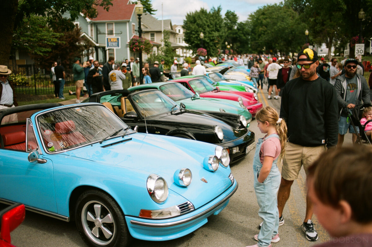 A row of brightly-colored Porsches at Carmel Artomobilia 2024