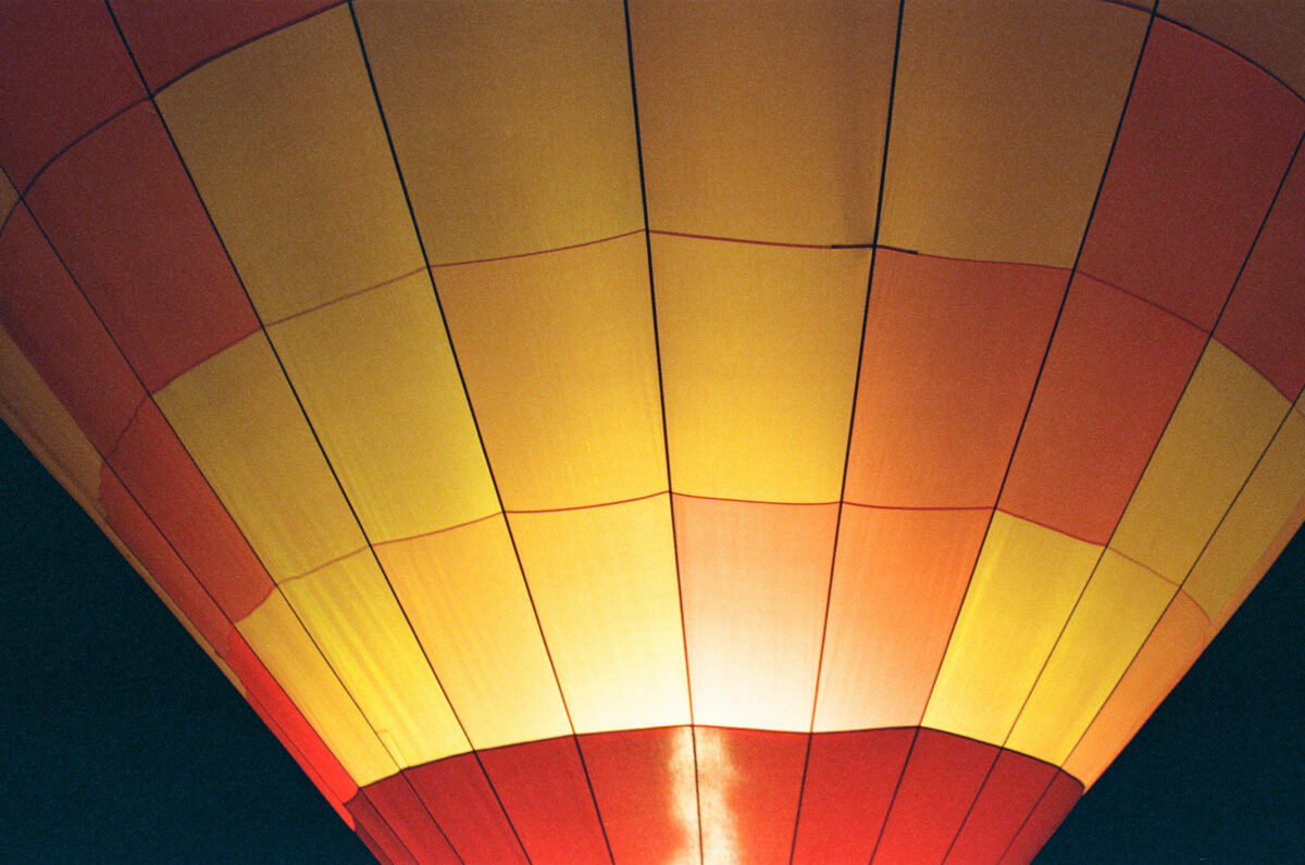 Close up of red, yellow, and orange hot air balloon. Photographing a Balloon Glow on film - Jupiter Flights Balloon Festival at Conner Prairie Image: Zach Dobson Photography