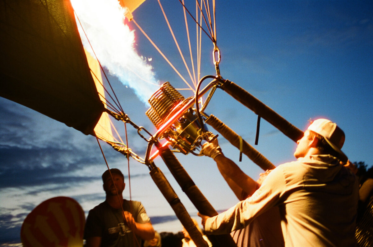 Firing up a hot air balloon. Photographing a Balloon Glow on film - Jupiter Flights Balloon Festival at Conner Prairie Image: Zach Dobson Photography