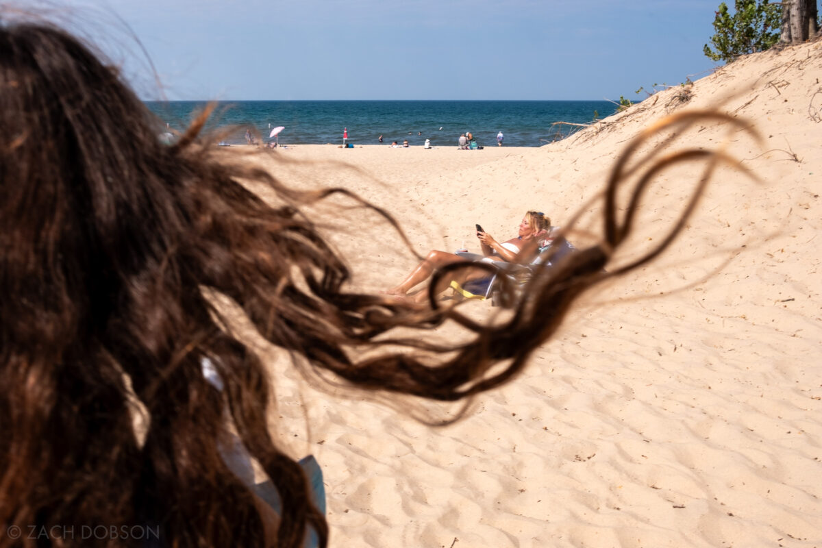 Sunbathing and hair blowing on Silver Beach on Lake Michigan in St. Joseph, Michigan.