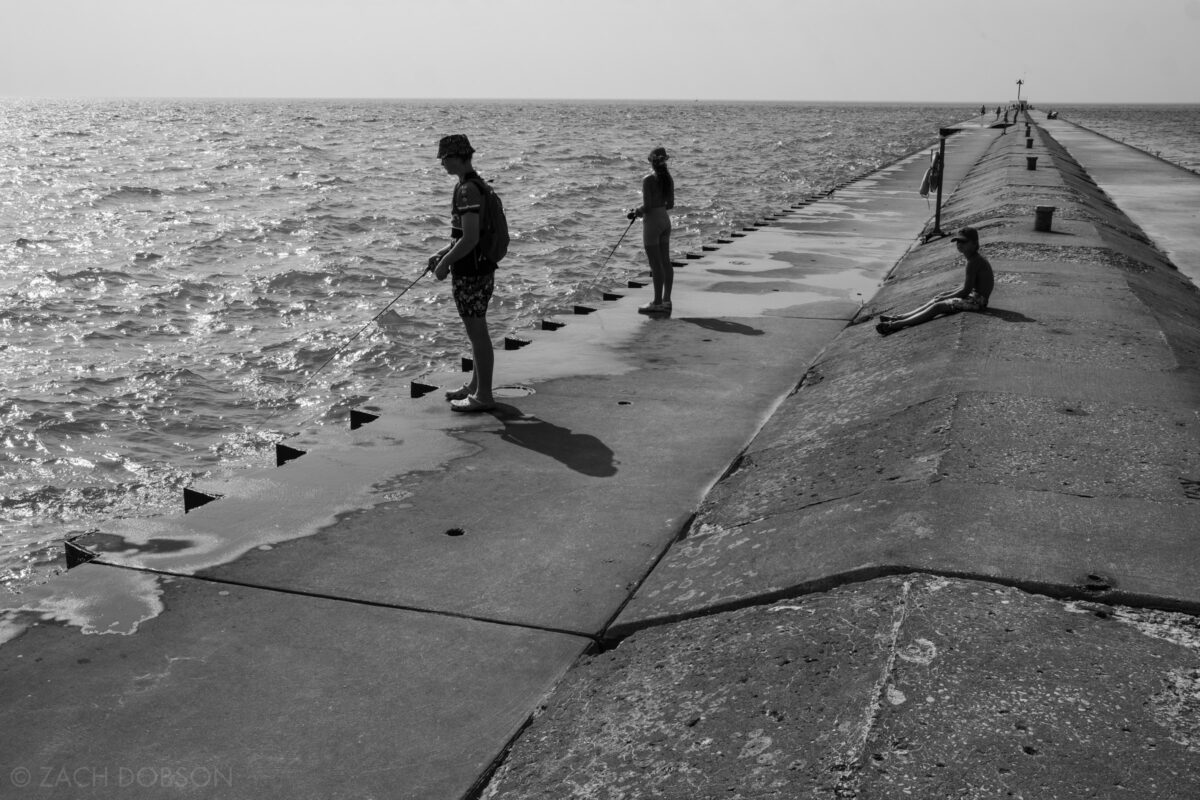 Fishing on the south pier where Lake Michigan meets St. Joseph River. Silver Beach, St. Joseph, Michigan.