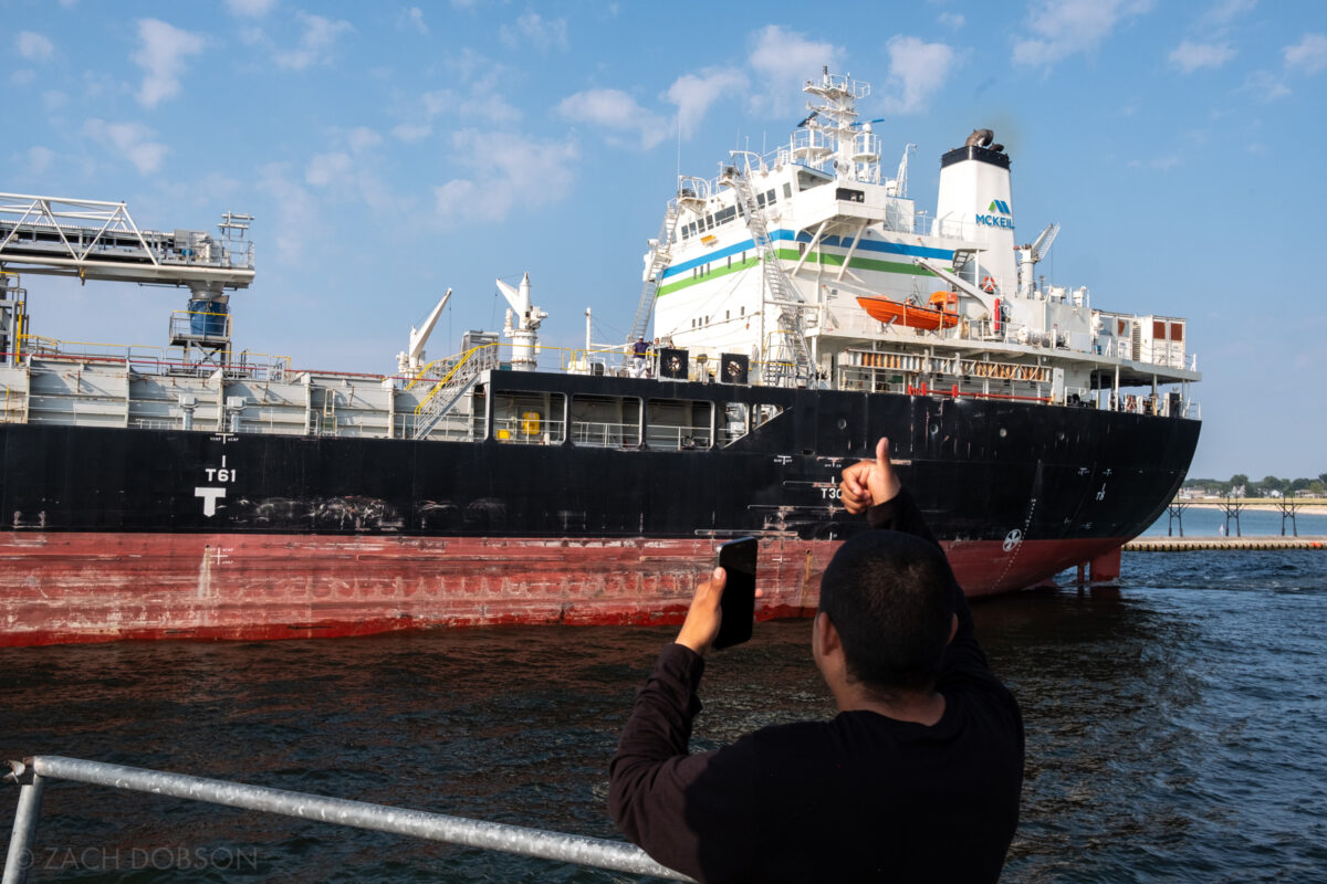 Watching Northern Venture freighter ship leave the St. Joseph River for Lake Michigan at Silver Beach in St. Joseph, Michigan