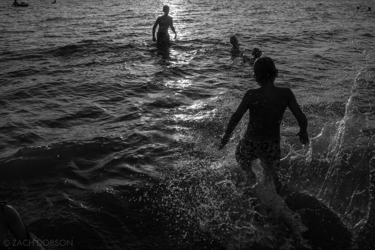 Swimming at sunset at Silver Beach on Lake Michigan in St. Joseph, Michigan.