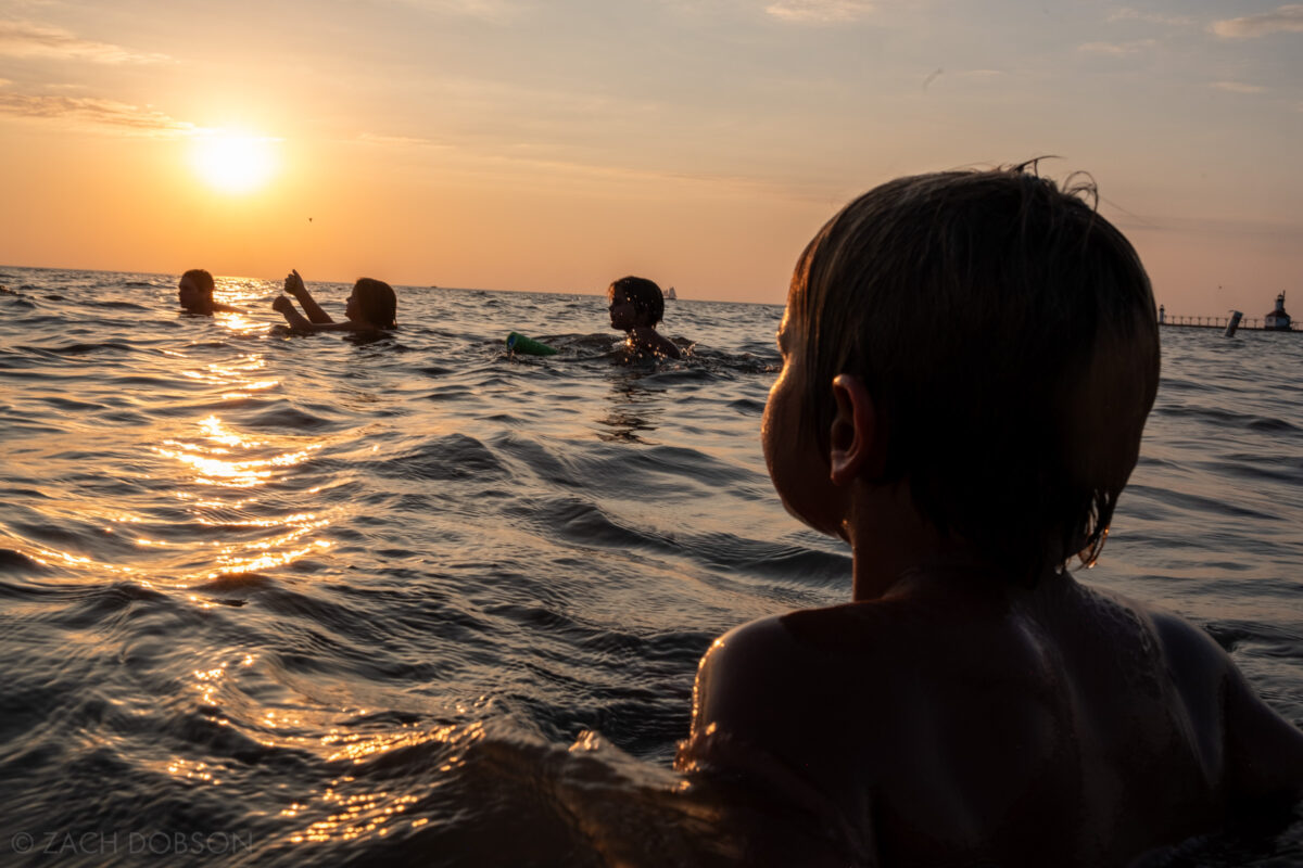 Swimming at sunset in Lake Michigan at Silver Beach in St. Joseph, Michigan