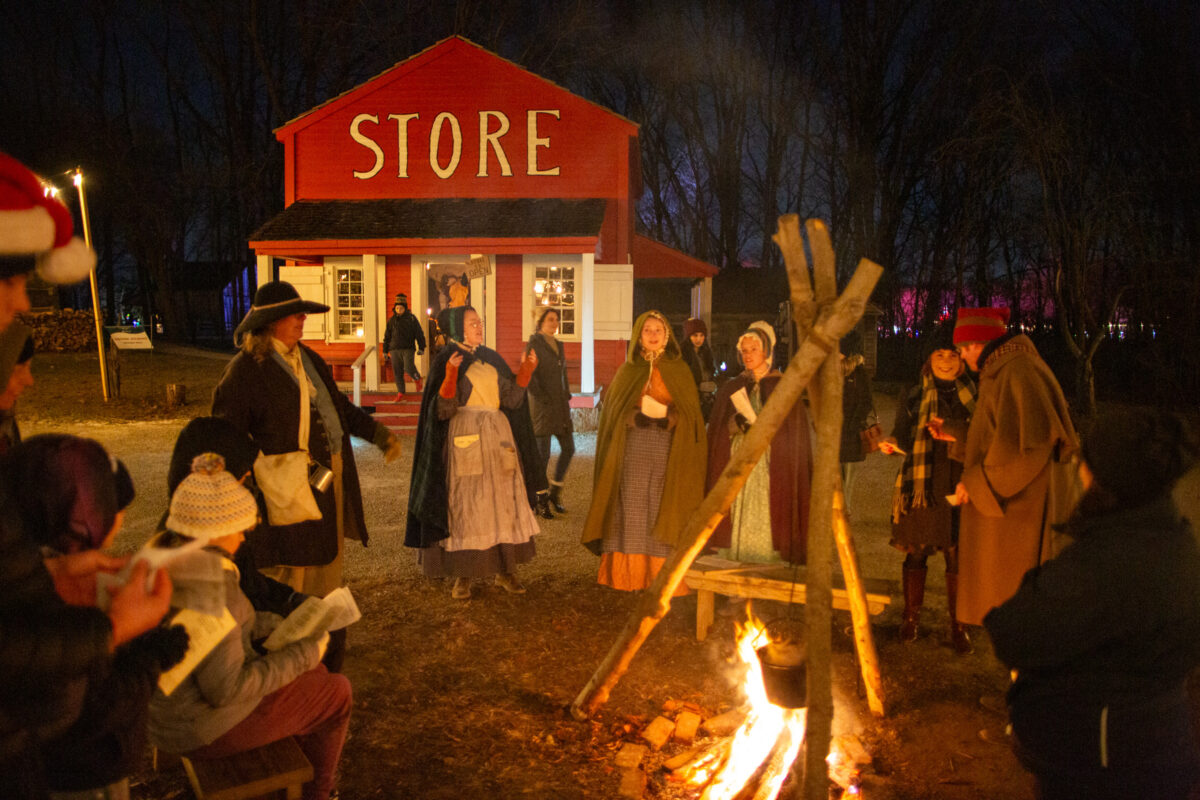 Singing around a camp fire at Conner Prairie, A Merry Prairie Holiday.