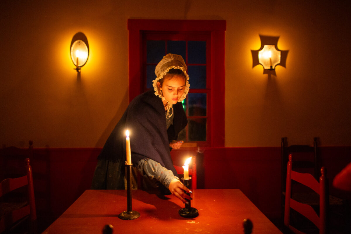 Lighting candles at Conner Prairie in Fishers, Indiana.