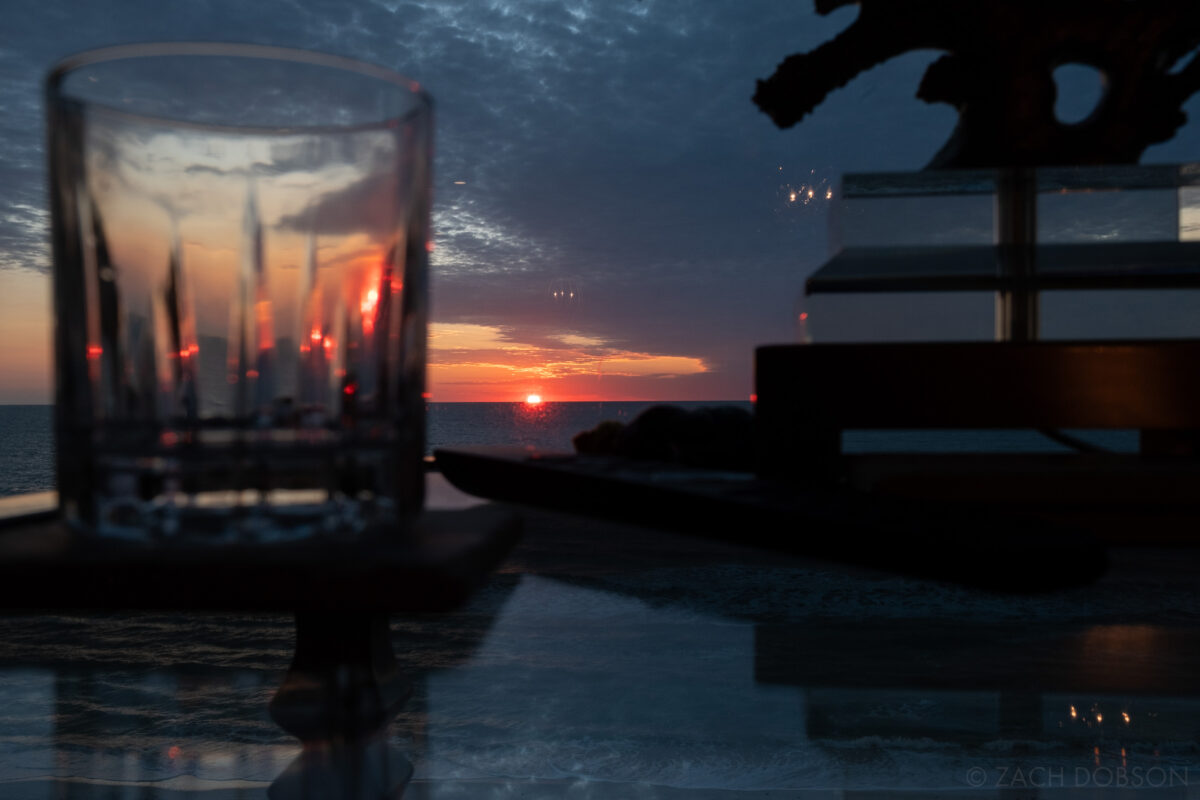 Sunset through a glass table and drinking glass. Bonita Springs, Florida.