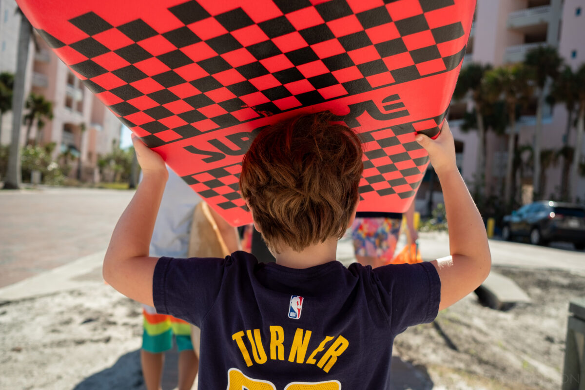 Carrying a boogie board to the beach. Bonita Springs, Florida.