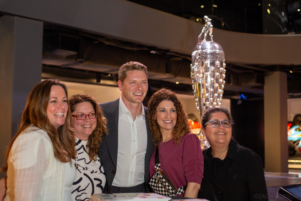 Josef Newgarden poses for a photo with fans at the Indianapolis Motor Speedway Museum