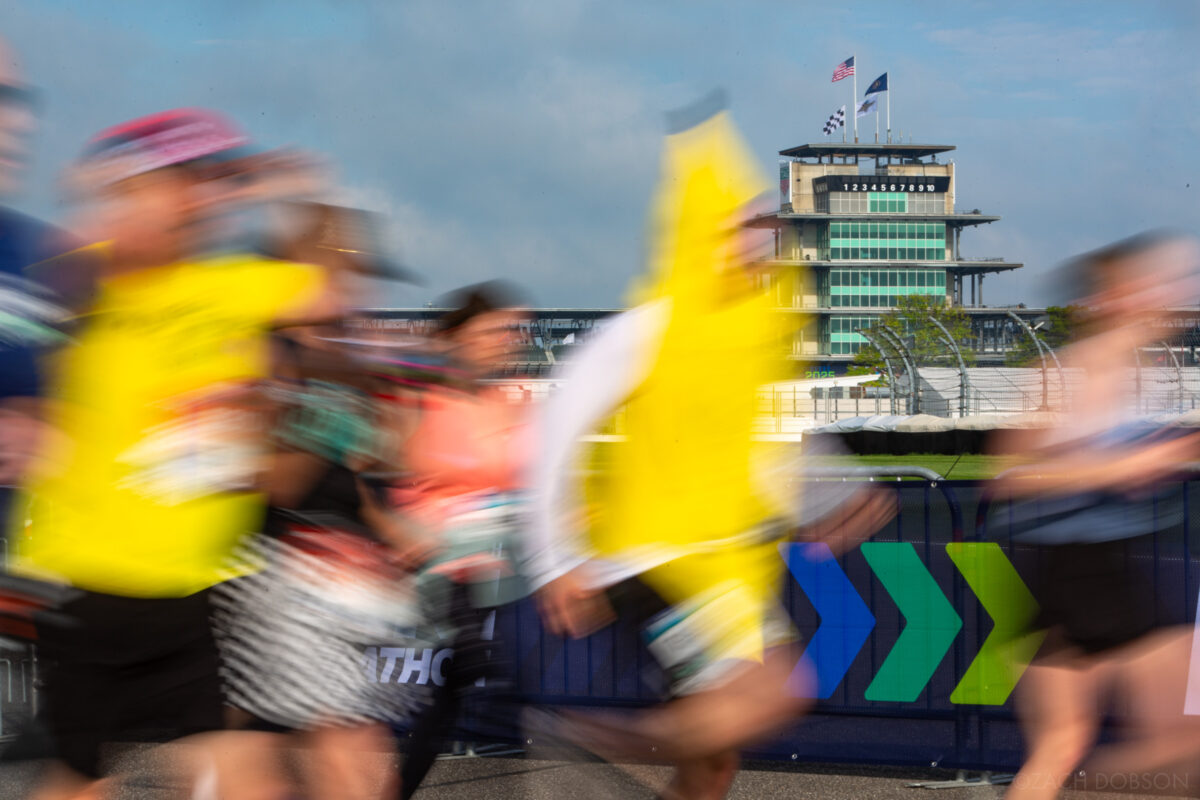 Runners take a lap around the Indianapolis Motor Speedway track during the 2025 Indiana University Health 500 Festival Mini Marathon in Indianapolis