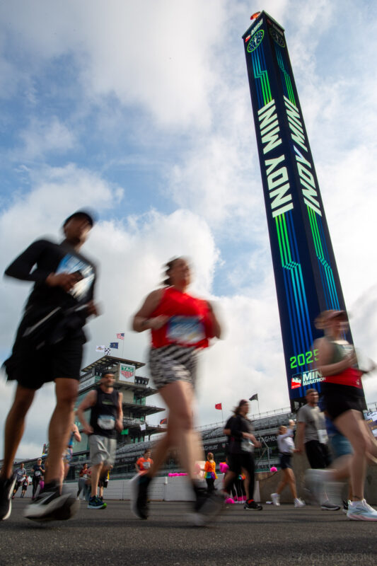 Runners take a lap around the Indianapolis Motor Speedway track during the 2025 Indiana University Health 500 Festival Mini Marathon in Indianapolis