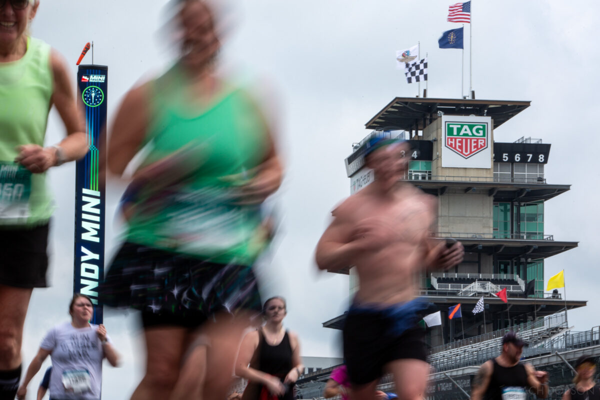 Runners take a lap around the Indianapolis Motor Speedway track during the 2025 Indiana University Health 500 Festival Mini Marathon in Indianapolis